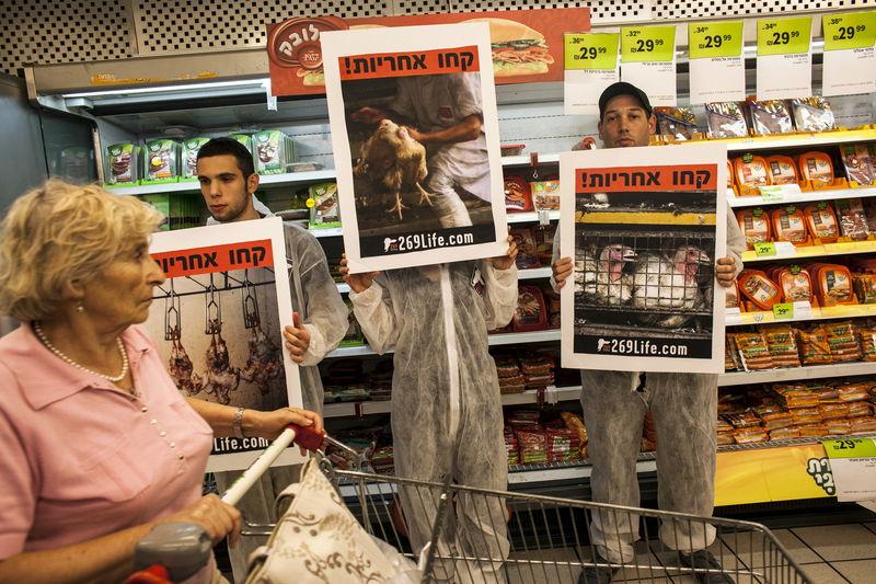File photo of activists standing in front of meat products at a supermarket in Tel Aviv