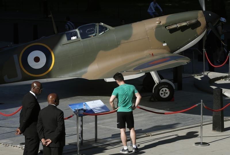 A man looks at a Mk.1 Spitfire on display outside the Churchill War Rooms in London